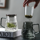 Glass tea cup with separate tea and water compartments for brewing